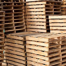 Thousands of wooden pallets at a pallet business pallet yard.