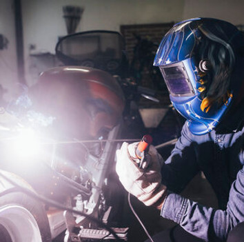 mature-man-in-garage-working-on-motorcycle-using-welding-equipment-CUF05706.jpg