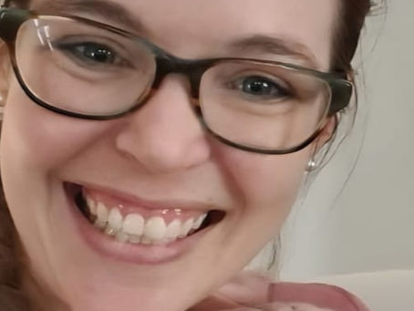 Mom with baby on her lap smiling