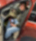 Mechanic using a diagnostic tool inside a vehicle dashboard