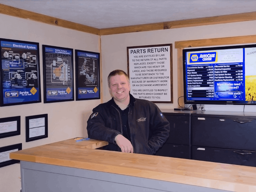 Employee smiling at NAPA Auto Parts counter