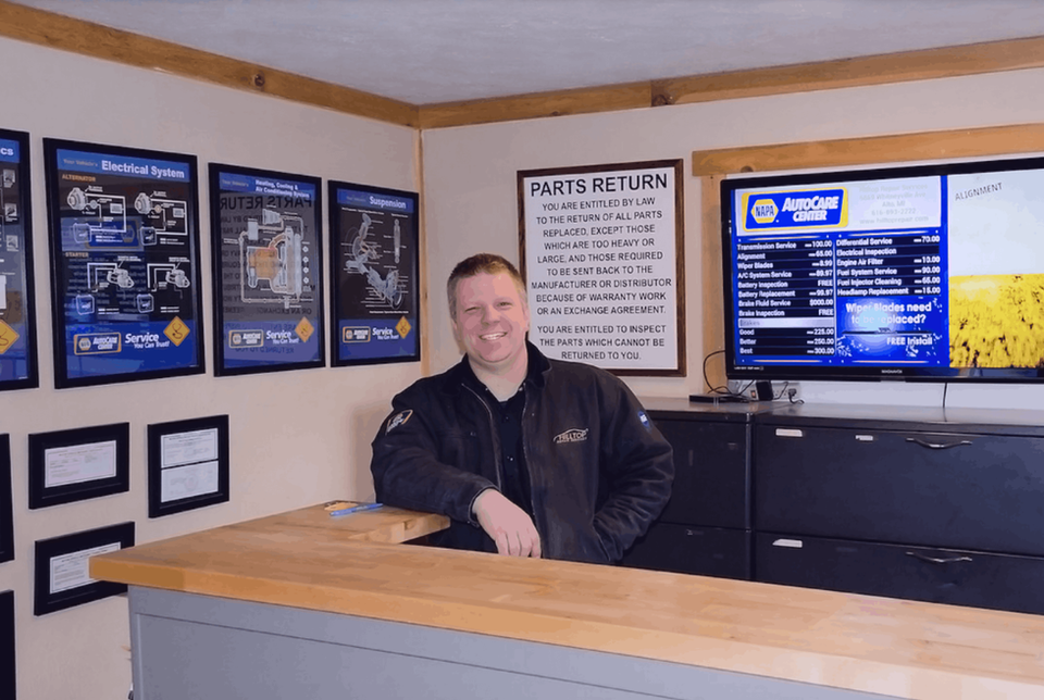 Employee smiling at NAPA Auto Parts counter
