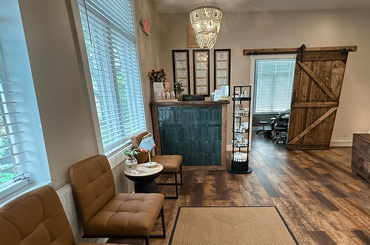 Modern reception area with leather chairs and barn door