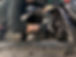 Mechanic in black gloves repairing a car engine