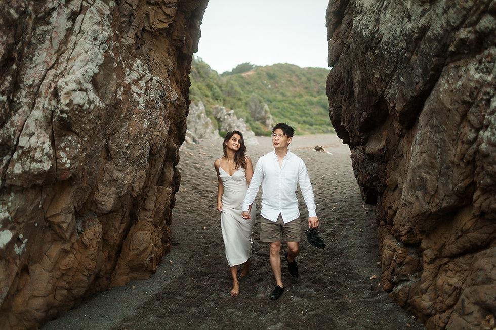 Capturing the essence of love, the engaged couple walks hand in hand through a picturesque cove. The soft waves caress the shore, creating a serene backdrop for this intimate moment during their engagement shoot.