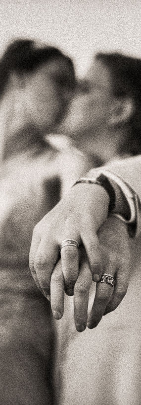 Celebrating love: Amalia and Rachel kissing, hands entwined, proudly displaying their wedding rings. Photographed by Kent Chua Photographer, Wellington Wedding Photographer.