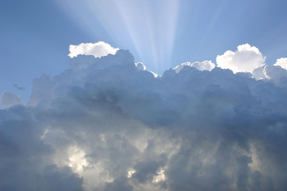 Bright sunlight breaking through dark storm clouds, symbolizing hope, faith, and inner strength.