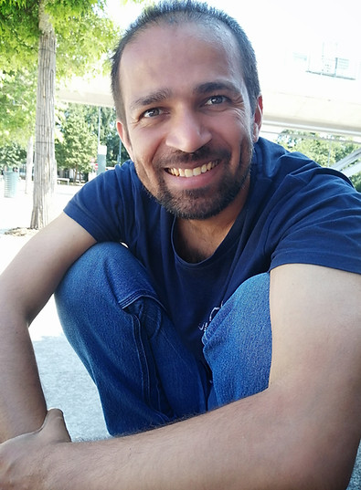 A smiling and welcoming portrait of Gajanan Aher, the Life Coach for Joy of Being in an outdoor setting.