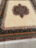 Thumbnail: Side view of the Royal icon Persian rug from Tabriz with a unique design in emerald green and burgundy on a beige background