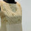 Thumbnail: Beige sleeveless dress with gold embellishments on the bodice, displayed on a black mannequin.