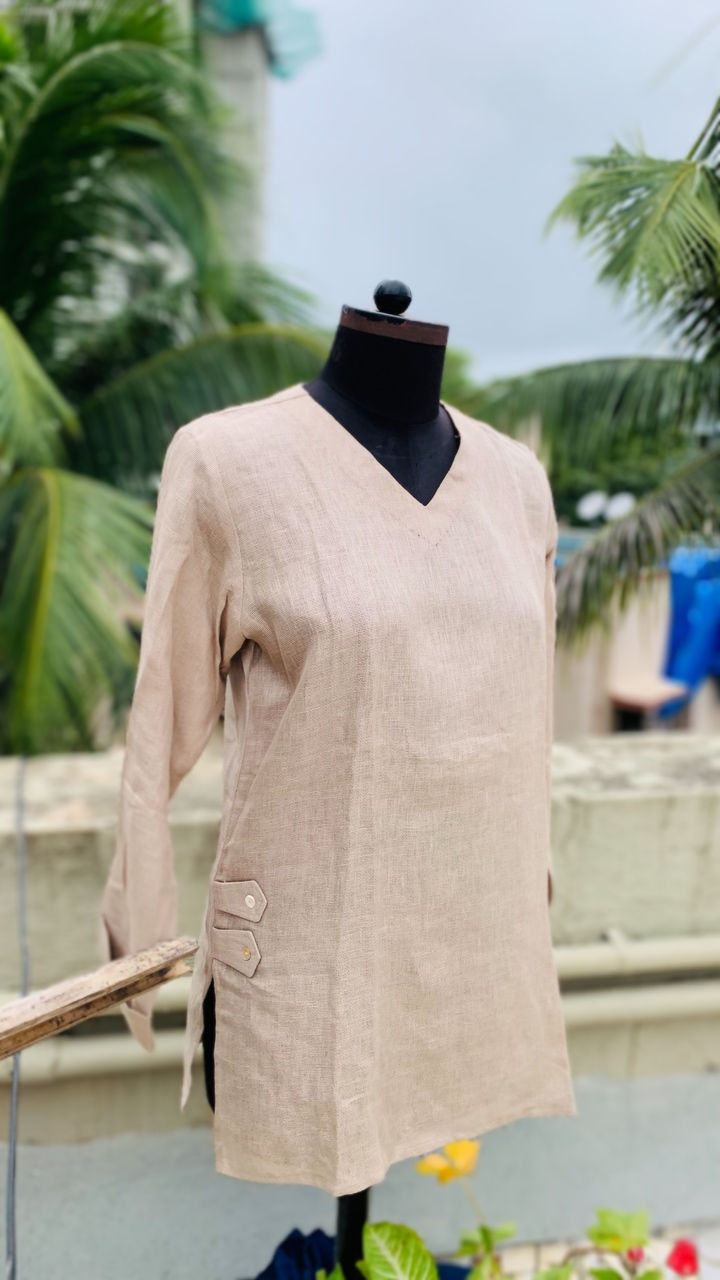 Model showcasing Azitiz linen kurti tunic in fawn with delicate embroidery, styled outdoors among trees and leaves