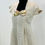 Thumbnail: A full view of a light beige linen dress displayed on a black mannequin, set against a plain white background. The dress features a square neckline, short sleeves, and a floral-patterned bow detail at the center of the chest, with imagery of birds and foliage. The bodice is fitted, and the skirt flares out slightly with soft pleats starting below the bust. The dress has a natural, breathable texture, giving it a casual yet refined appearance.
