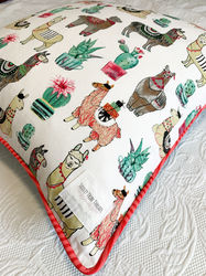 Soulty Tribe Threads Home Decor - Glama-Llama Euro Cushion with piping laying on bed covered with Laura Ashley bedspread. 