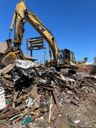 Construction debris pile after house demolition with excavator in Los Angeles