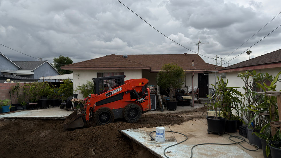 Excavated backyard after pool demolition showing cleared space