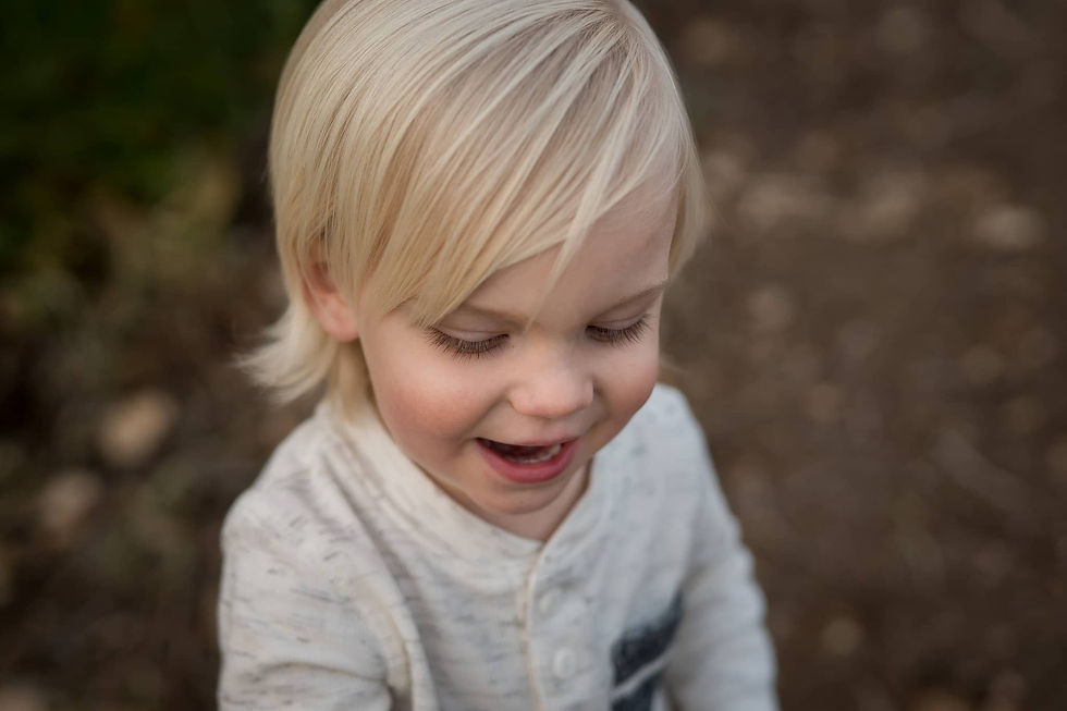 A toddler's candid smile of delight.