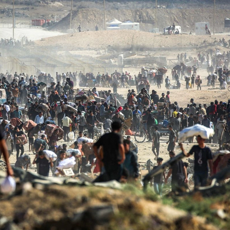     Personas caminan con paquetes de ayuda humanitaria recibidos de un centro de distribución gestionado por la Fundación Humanitaria de Gaza (FGH), respaldada por Estados Unidos e Israel, en el llamado "corredor Netzarim", en Nuseirat, en el centro de la Franja de Gaza, el 30 de septiembre de 2025. Foto Afp