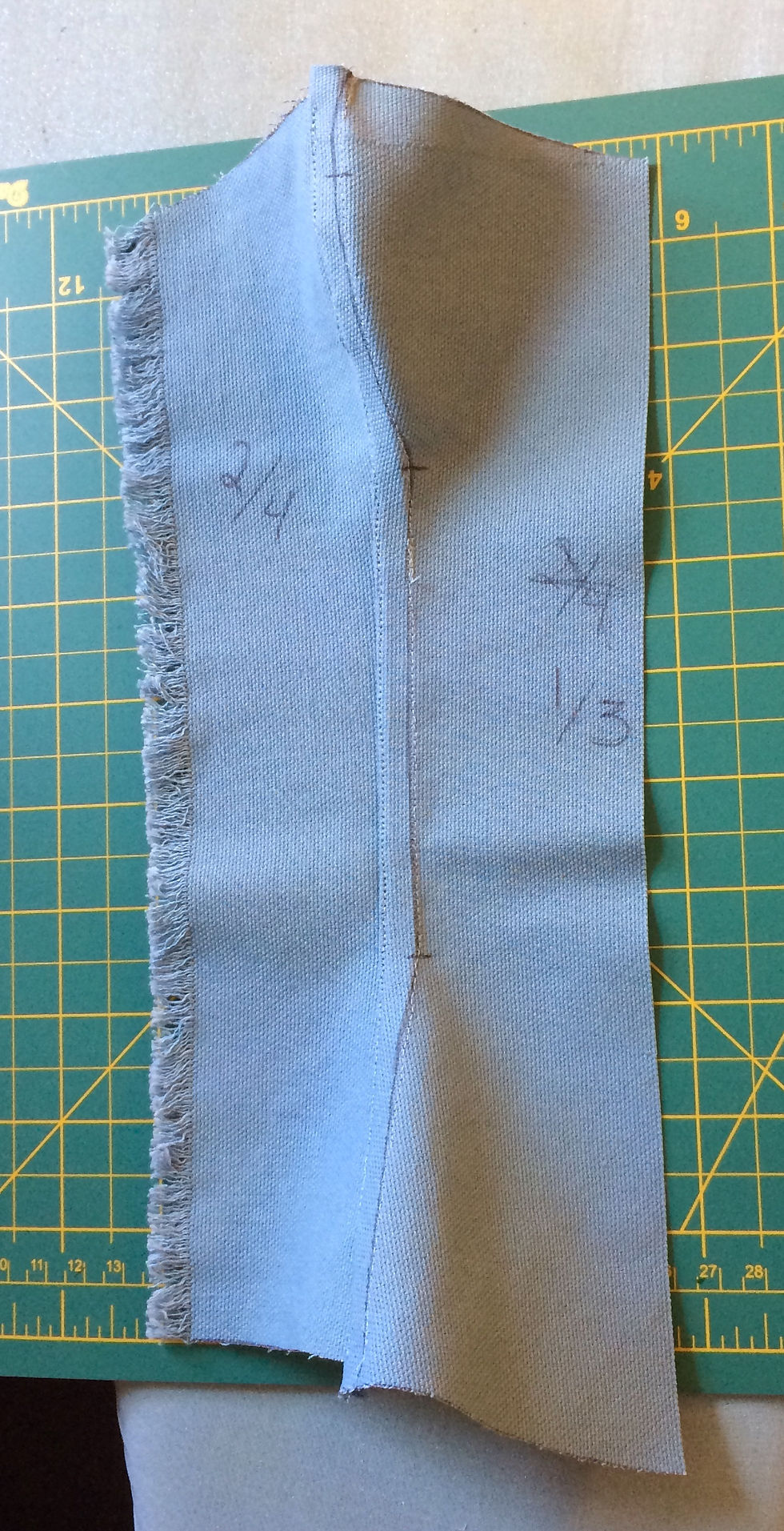 Two curved pieces of fabric joined by a flat felled seam