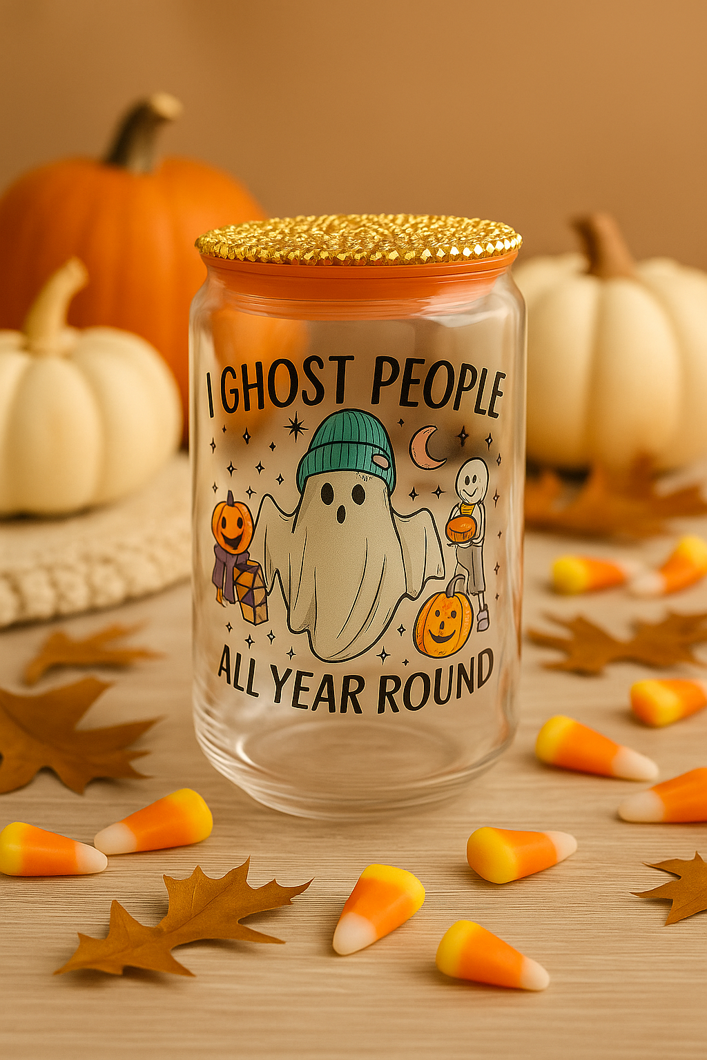 Funny Halloween glass cup with ghost design and seasonal decorations.