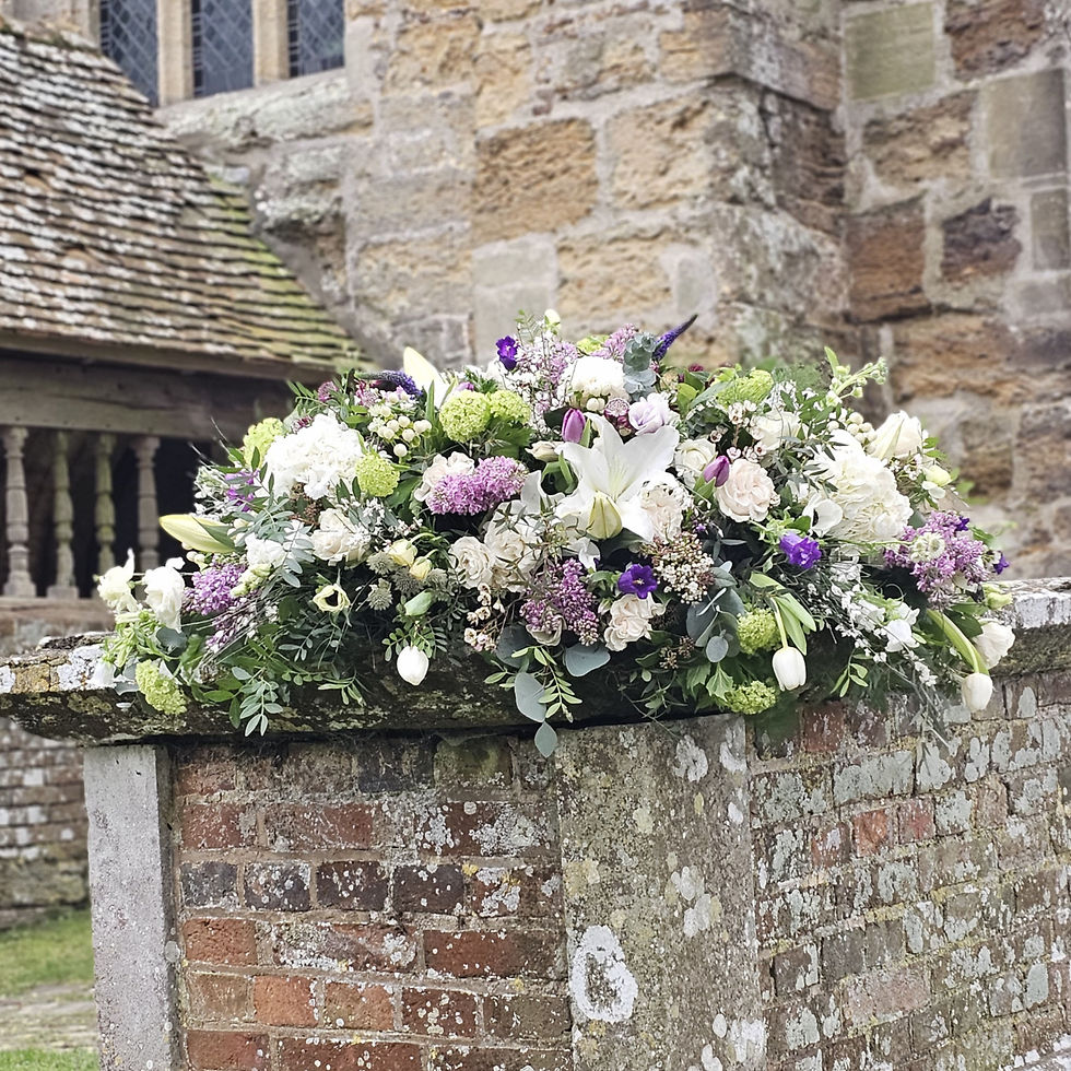 Purple and white casket spray