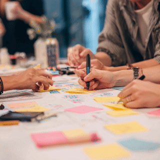 ud_collective_Top_close_up_view_of_3_designers_working_at_a_t_6403c38e-2ea2-4c81-a6d0-2f41