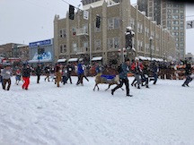 men's "herd" running with the reindeer