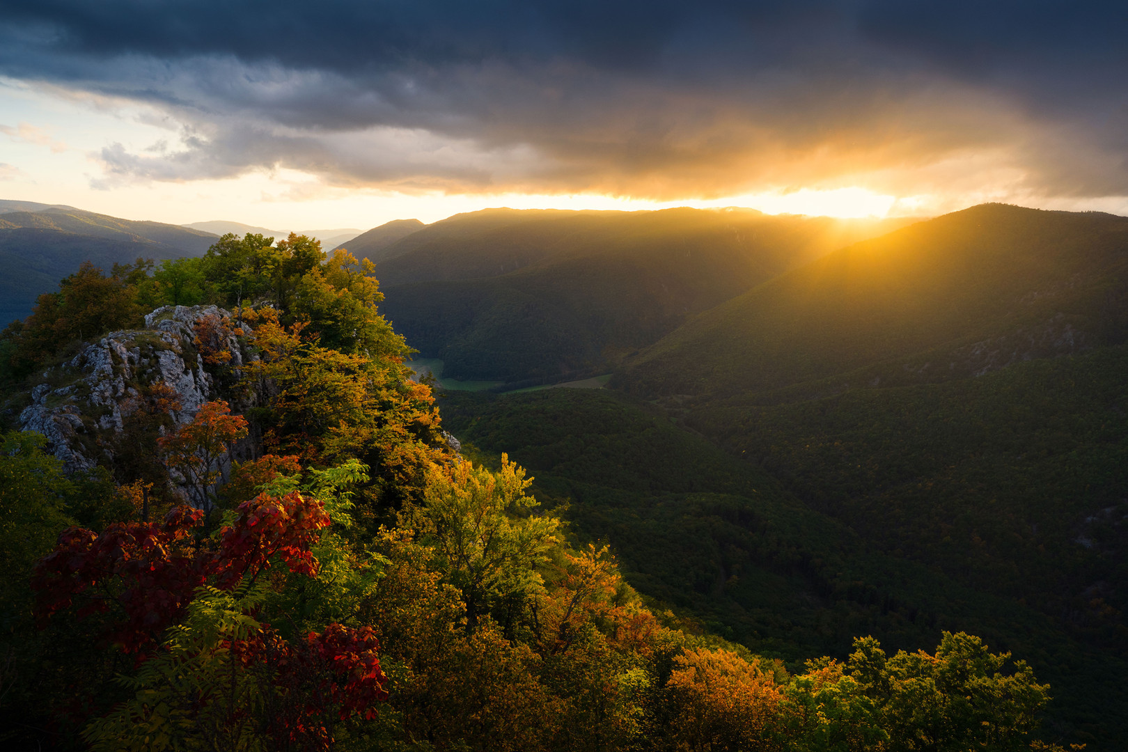 Sunset over colorful autumn tree leaves in the Muránska planina in Slovakia.