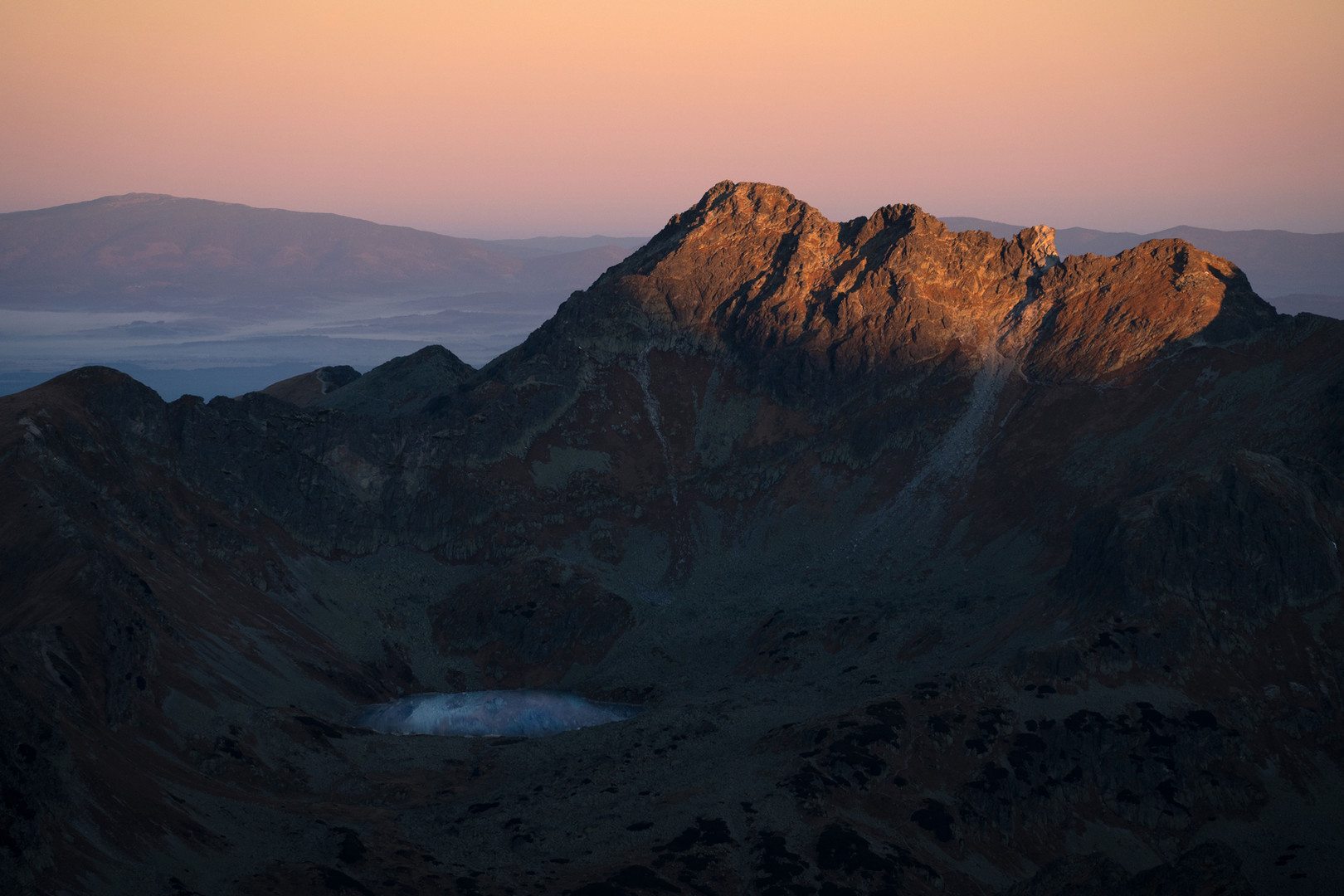 Sunrise in the Slovak Tatras, with the sun coloring the mountain peaks.