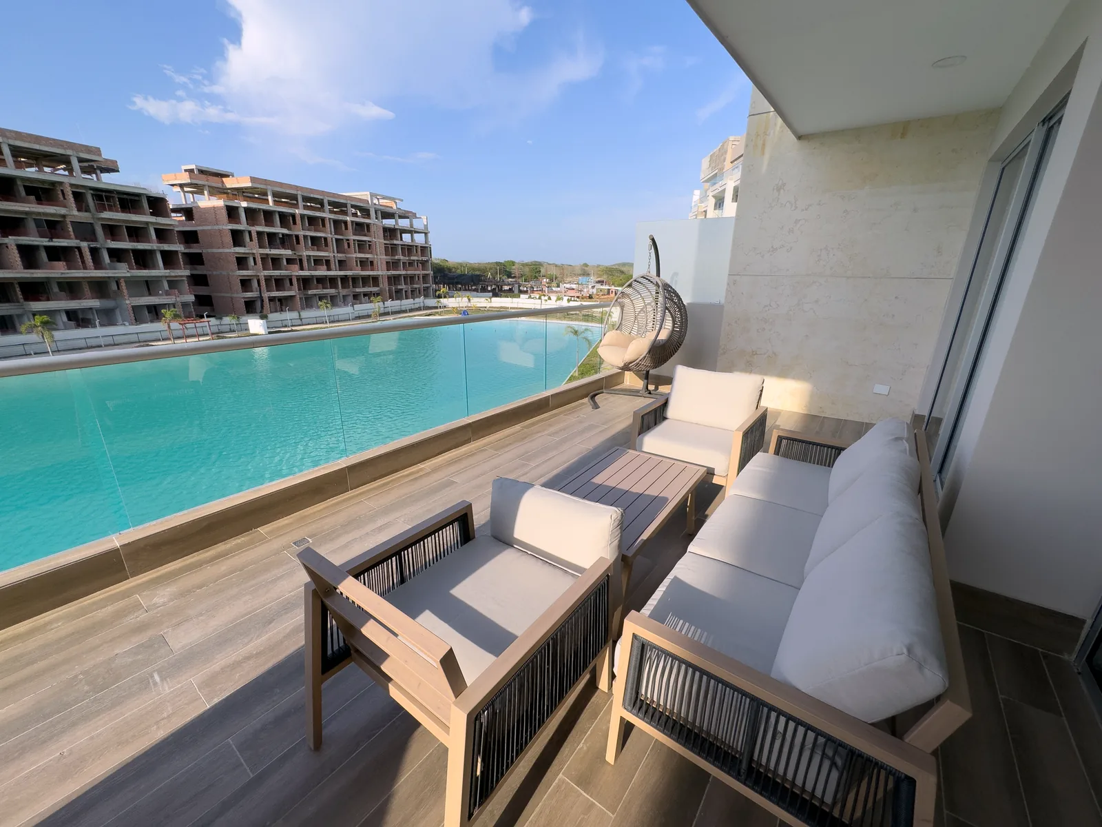 Balcón con mesa y sillas frente a la laguna del apartamento P33D en Baia Kristal.