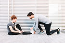 man-massaging-stretched-leg-woman.jpg