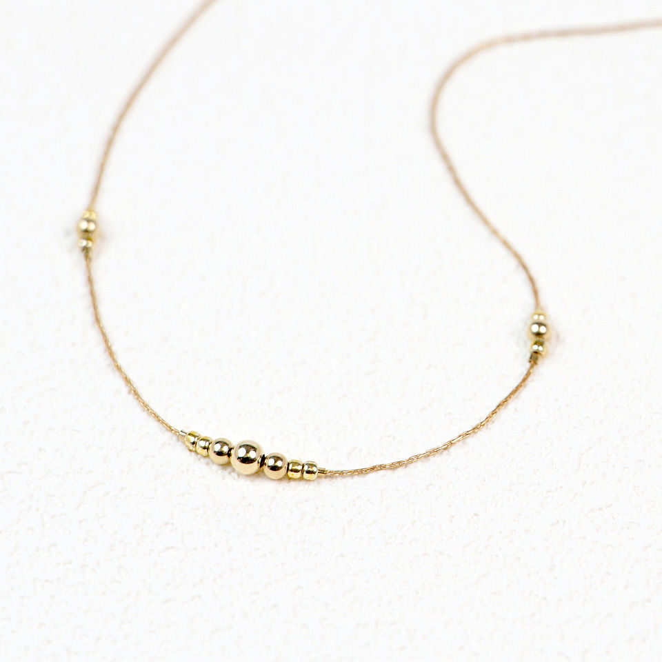 Tallulah Necklace flatlay on textured paper