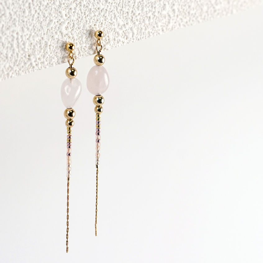 Rina Earrings hanging styled shot on textured paper