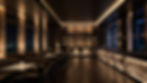 dimly-lit-bar-with-green-leather-chairs-dark-wood-tables.jpg