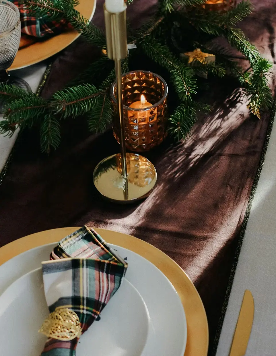 Festive holiday decorated table set for event.