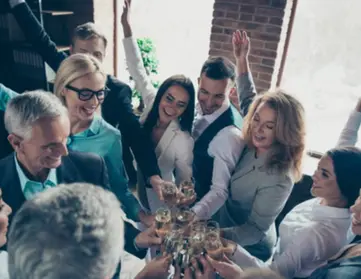 Office employees cheers with champagne. 