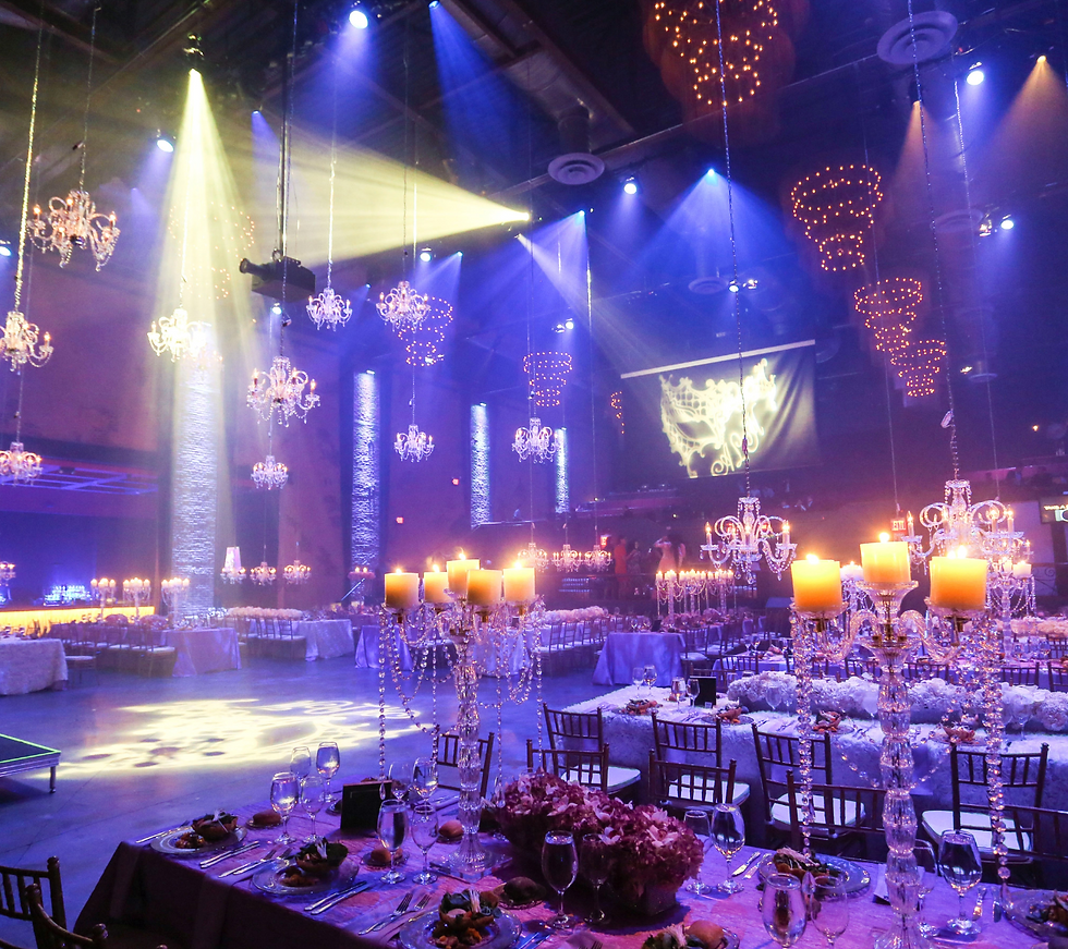 A grand banquet hall featuring elegant chandeliers and beautifully arranged tables, showcasing the venue's impressive entrance.