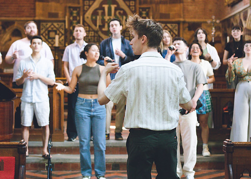 man-music-directing-choir-in-church-recording-session