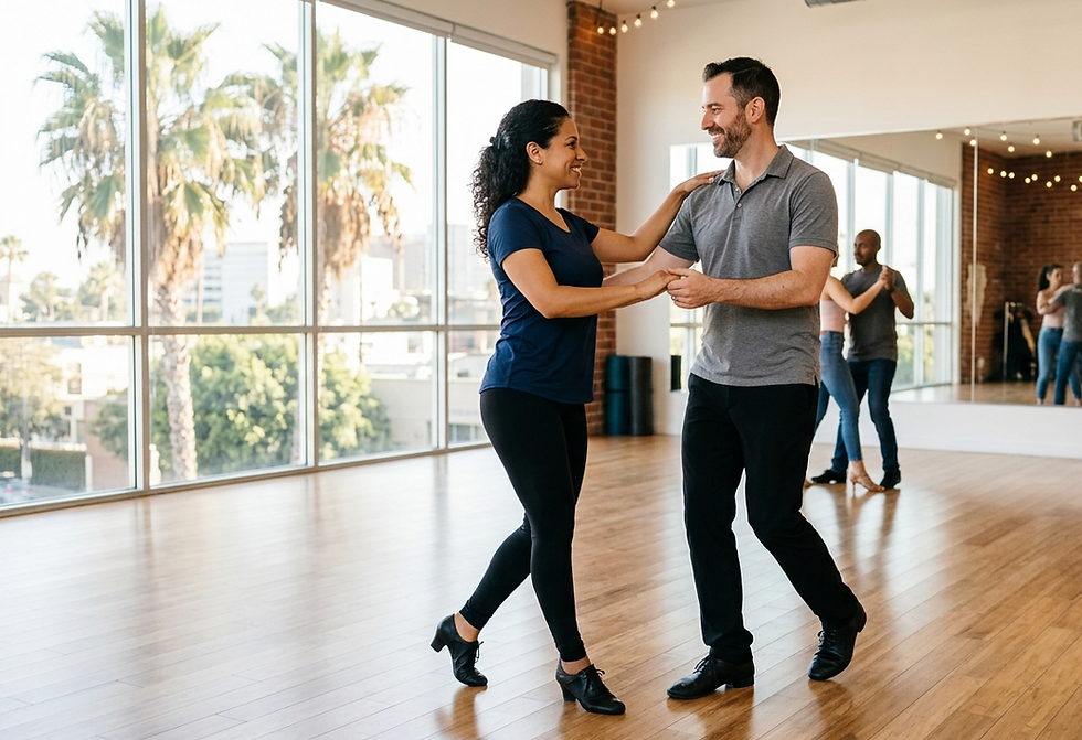Adult couple practicing safe salsa and bachata technique with balanced posture and controlled footwork in a Los Angeles dance studio.