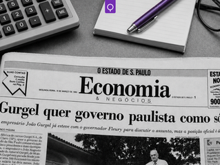 Imagem em preto e branco de uma edição de 1993 do caderno Economia & Negócios do jornal O Estado de S. Paulo, aberta na reportagem “Gurgel quer governo paulista como sócio”, assinada por Marco Piquini. Ao redor do jornal aparecem calculadora, bloco de anotações, óculos e uma caneta roxa em destaque. A imagem ilustra o artigo “Anjas da guarda na redação”, sobre aprendizados e mentoria na trajetória jornalística de Marco Piquini no Estadão.