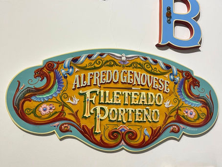 A painted Fileteado sign.