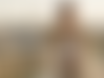 A model on a rooftop terrace overlooking the Paris skyline. She is wearing a chic, upcycled 1940s vintage blazer with intricate gold Tambour beadwork.