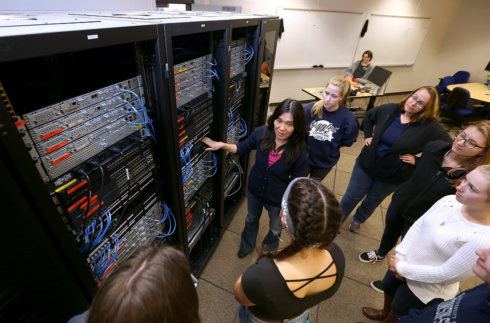 Professor Holly Yuan, at center, instructing students in a UW-Stout CNIE lab.