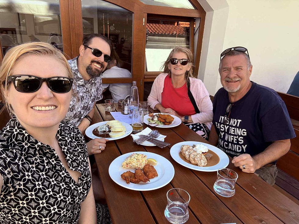 Family smiling with meal in Prague 
