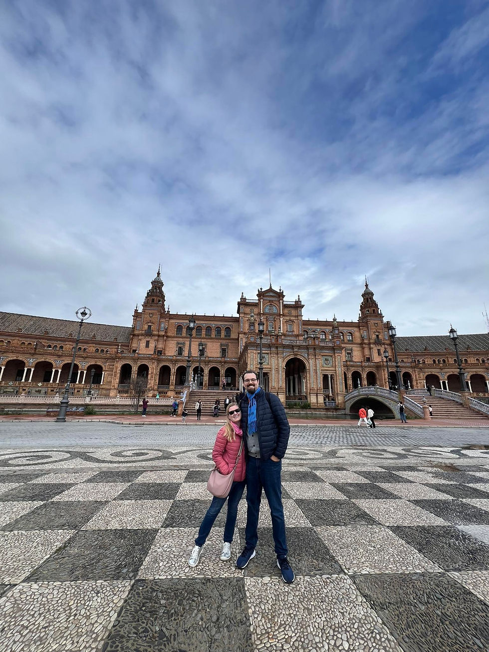 Couple smiling in front of Plaza de Espana