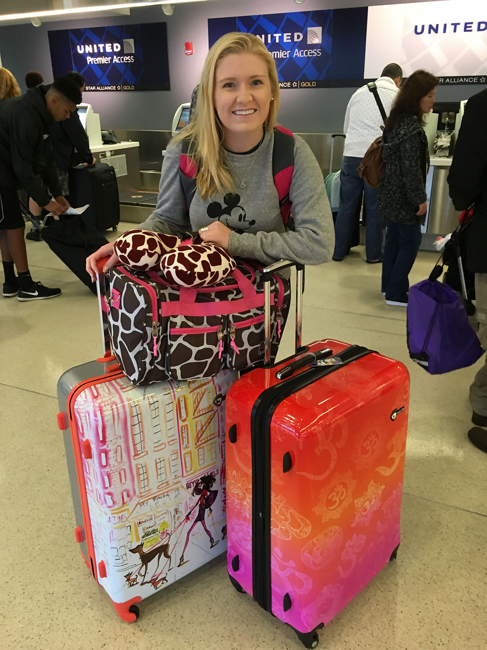 Woman smiling with suitcases at airport