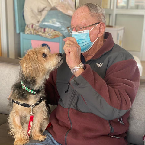 Photo of man with his newly adopted small dog.