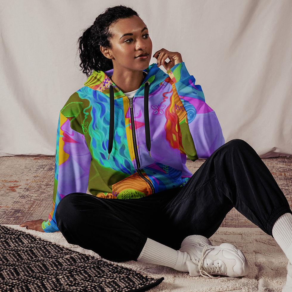 Woman wearing colorful zip-up hoodie, sitting casually, ArtDivaArt on neutral background.