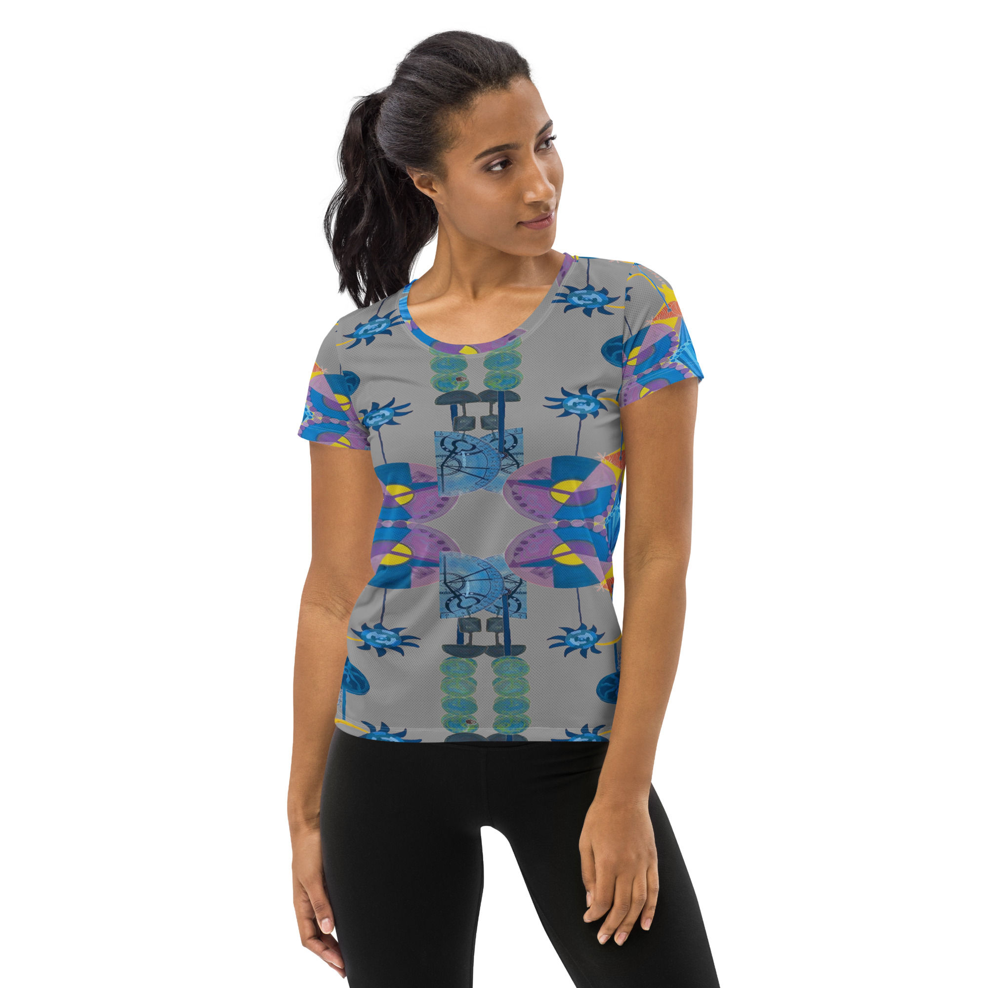 Woman wearing patterned athletic shirt, black leggings, ArtDivaArt design. Activewear attire.