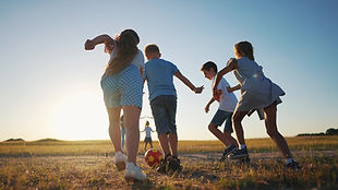 happy family playing ball in the park. group of children playing ball in nature. happy fam