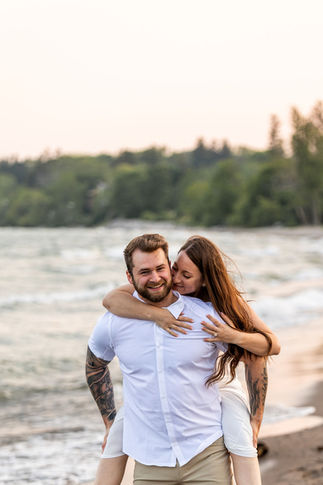 Golden hour engagement photography at Frenchman’s Bay featuring natural candid moments by the lake